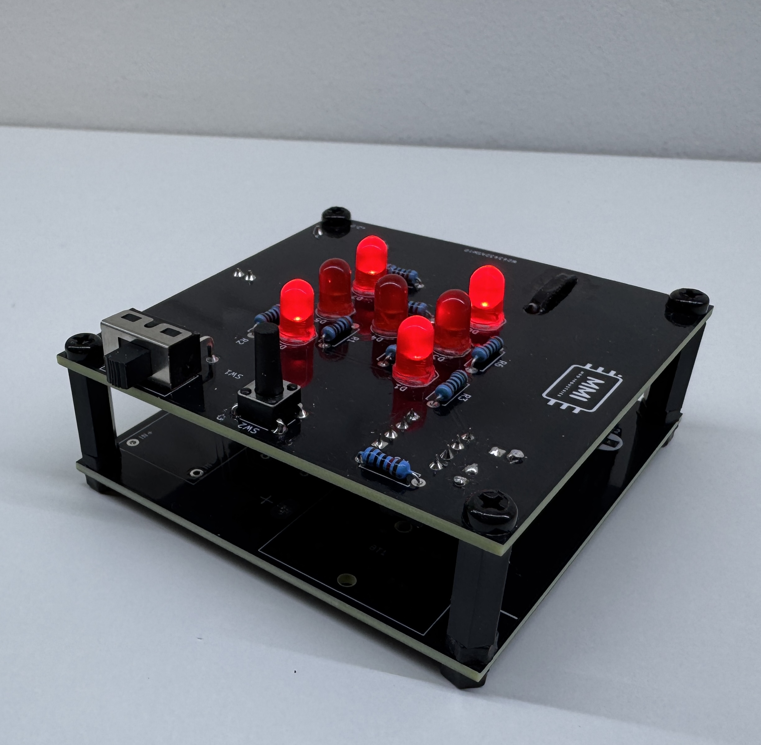 ArcDice assembled prototype with all 7 LEDs lit showing a 6